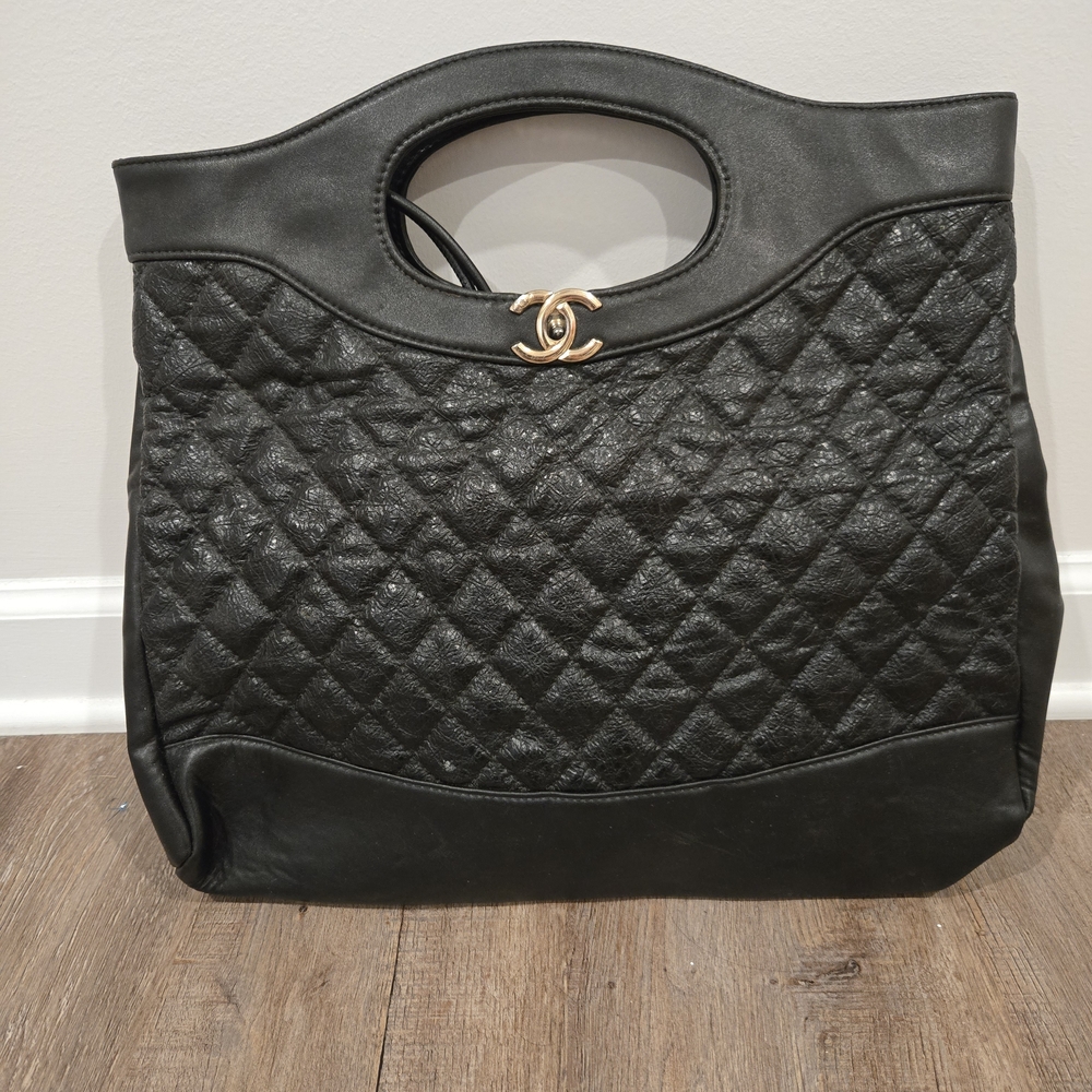 CHANEL Black Quilted Clutch with Gold Accent